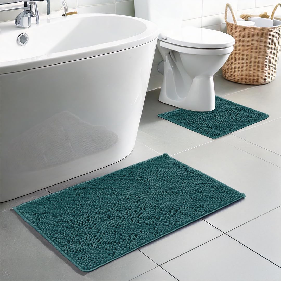 Angled view of teal Muddy Mat bath mat set showing chunky chenille texture with U shaped toilet mat on gray tiled bathroom floor